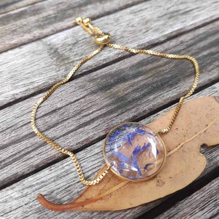 bracelet coulissant en acier inoxydable doré avec inclusion de fleur de bleuet - bijou fleur