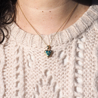 Bijoux vraies fleurs Clermont - Mini médaillon doré couleur émeraude avec une fleur de carotte sauvage - porté